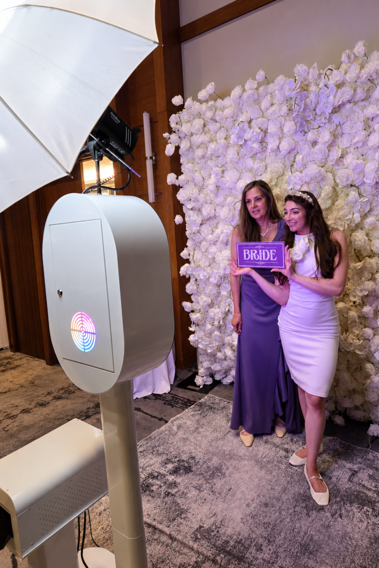 bride taking picture with photobooth
